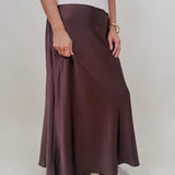 Juliette Satin Midi Skirt in chocolate brown with a smooth elastic waist and a bias cut silhouette that flares softly at the hem