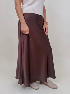 Juliette Satin Midi Skirt in chocolate brown with a smooth elastic waist and a bias cut silhouette that flares softly at the hem