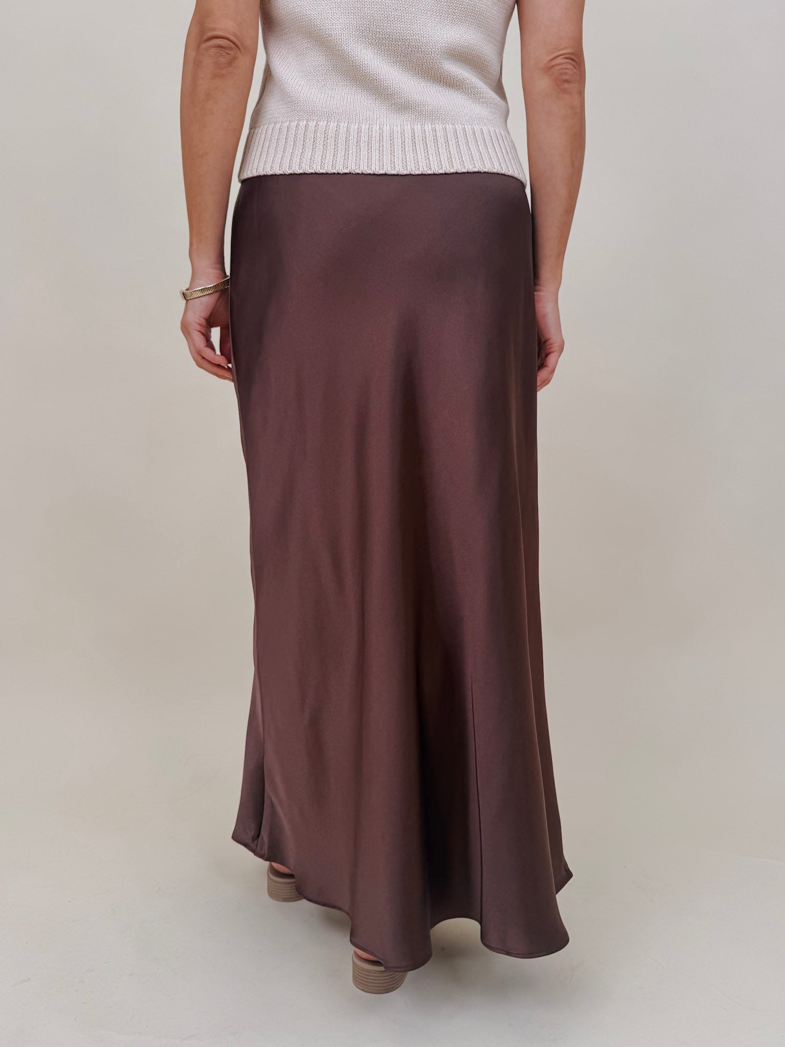 Juliette Satin Midi Skirt in chocolate brown with a smooth elastic waist and a bias cut silhouette that flares softly at the hem