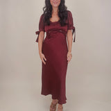 Katrina Midi Dress in olive crinkled satin with lace trim at the sweetheart neckline and empire waist, puff sleeves with bow ties, and a flowing bias cut midi skirt