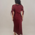 Katrina Midi Dress in burgundy crinkled satin with lace trim at the sweetheart neckline and empire waist, puff sleeves with bow ties, and a flowing bias cut midi skirt