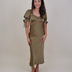 Katrina Midi Dress in olive crinkled satin with lace trim at the sweetheart neckline and empire waist, puff sleeves with bow ties, and a flowing bias cut midi skirt