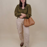 Kortni Blouse in martini olive with tonal brown polka dots, a ruffle collar, tie front V neckline, and balloon sleeves