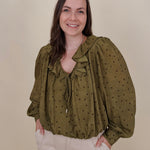 Kortni Blouse in martini olive with tonal brown polka dots, a ruffle collar, tie front V neckline, and balloon sleeves