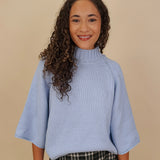 Long Island Sweater in powder blue with a folded ribbed mock neck, wide bell sleeves, and a relaxed boxy cotton knit body