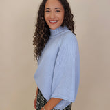 Long Island Sweater in powder blue with a folded ribbed mock neck, wide bell sleeves, and a relaxed boxy cotton knit body