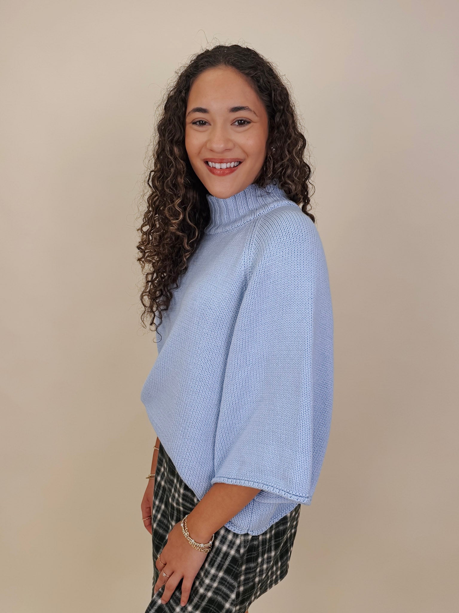 Long Island Sweater in powder blue with a folded ribbed mock neck, wide bell sleeves, and a relaxed boxy cotton knit body