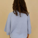 Long Island Sweater in powder blue with a folded ribbed mock neck, wide bell sleeves, and a relaxed boxy cotton knit body