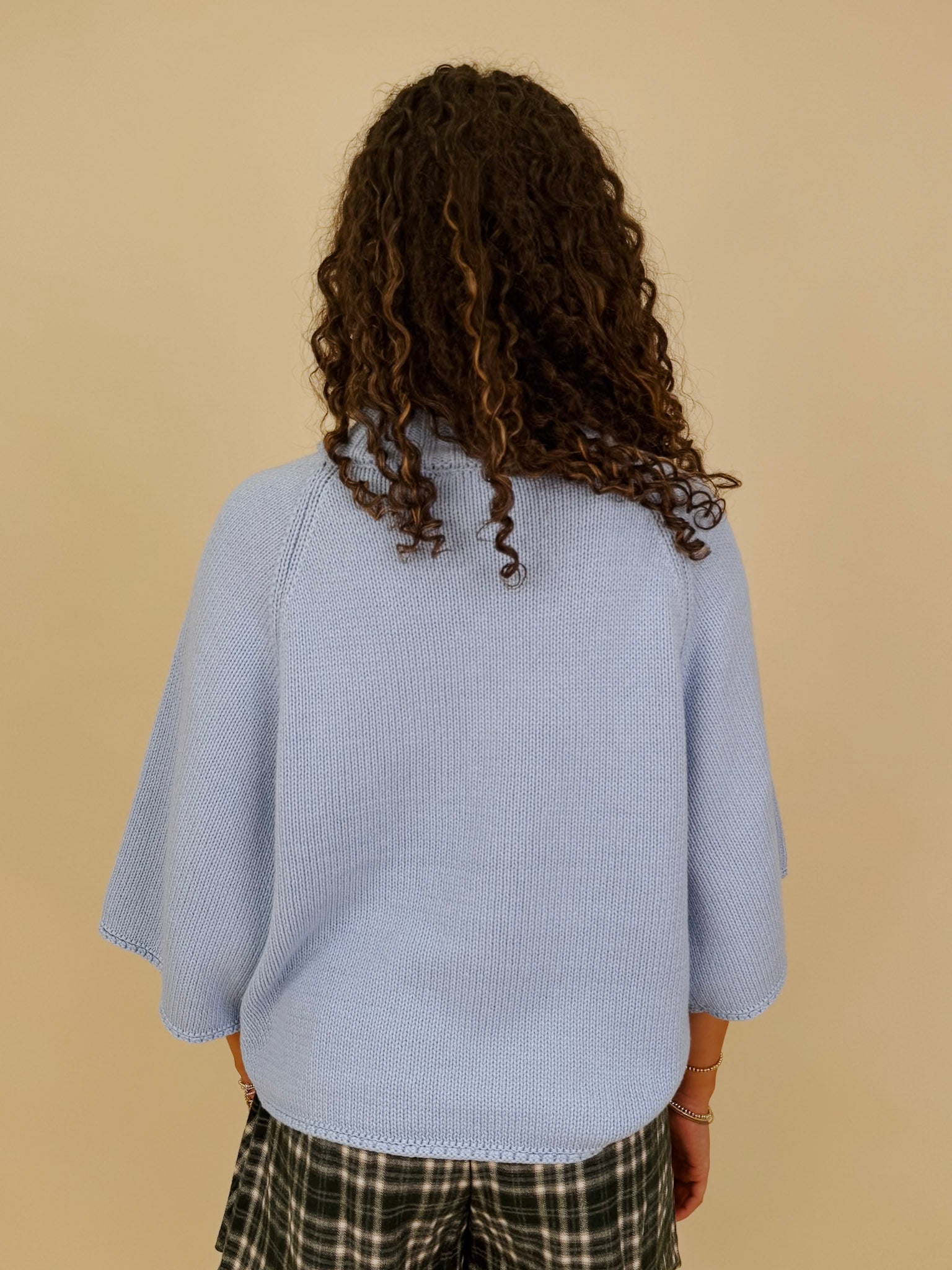 Long Island Sweater in powder blue with a folded ribbed mock neck, wide bell sleeves, and a relaxed boxy cotton knit body
