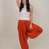 Magazine Street Pant in rust cotton with a smocked drawstring waist, gathered yoke, side pockets, and a full balloon leg