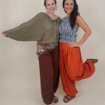 Magazine Street Pant in rust cotton with a smocked drawstring waist, gathered yoke, side pockets, and a full balloon leg