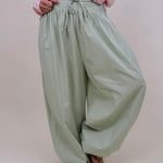 Magazine Street Pant in light olive cotton with a smocked drawstring waist, gathered yoke, side pockets, and a full balloon leg