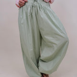 Magazine Street Pant in light olive cotton with a smocked drawstring waist, gathered yoke, side pockets, and a full balloon leg