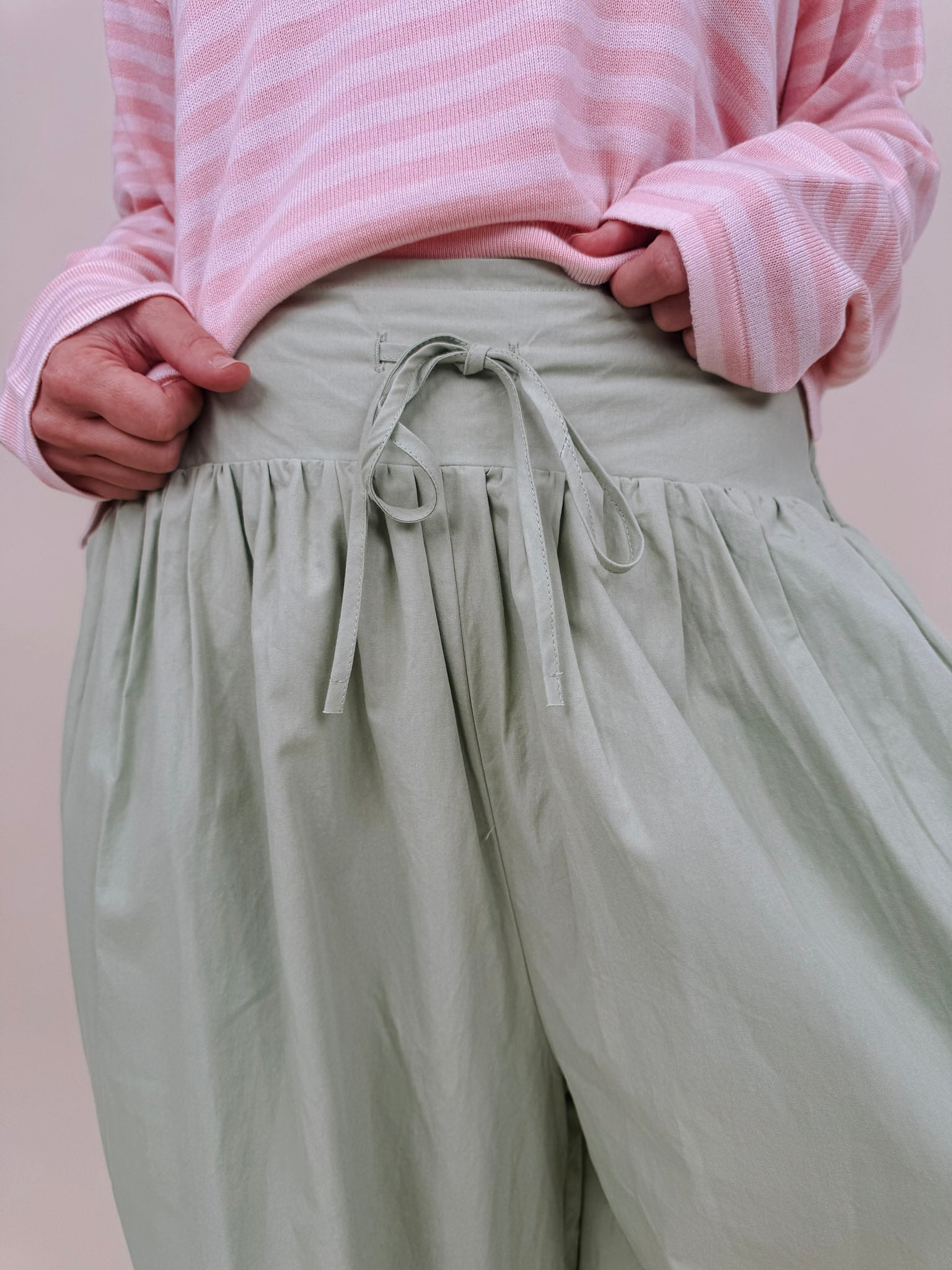 Magazine Street Pant in light olive cotton with a smocked drawstring waist, gathered yoke, side pockets, and a full balloon leg