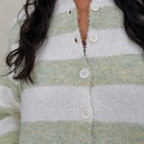 Melanie Striped Cardigan in sage green and cream stripes with a white button front, ribbed cuffs, and a slightly cropped brushed knit body