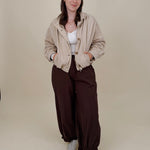 Pumpkin Patch Denim Jacket in soft beige with tortoise buttons over a hidden zip front, gathered shoulders, welt pockets, and an elastic bubble hem