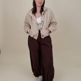 Pumpkin Patch Denim Jacket in soft beige with tortoise buttons over a hidden zip front, gathered shoulders, welt pockets, and an elastic bubble hem