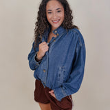 Pumpkin Patch Denim Jacket in medium wash denim with tortoise buttons over a hidden zip front, gathered shoulders, welt pockets, and an elastic bubble hem