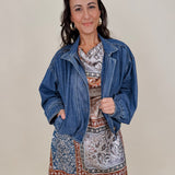 Pumpkin Patch Denim Jacket in medium wash denim with tortoise buttons over a hidden zip front, gathered shoulders, welt pockets, and an elastic bubble hem