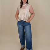 So Long London Blouse in champagne satin with eyelash lace panels, a mock neckline, cap sleeves, and a ruffled peplum hem with a ribbon tie back