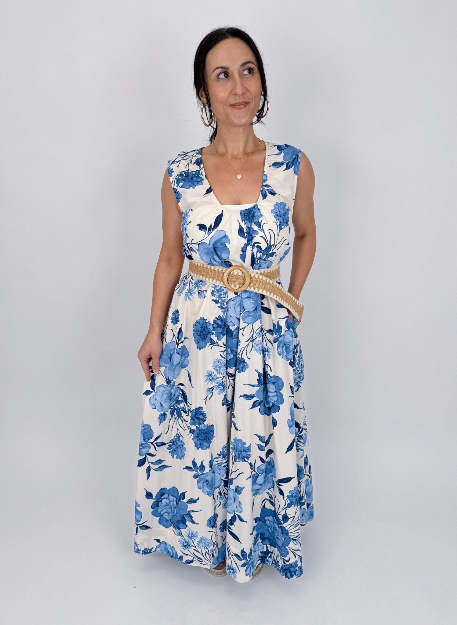 Not A Day Late Floral Maxi Dress in blue and white floral cotton print with deep V neckline, wide straps, and tiered maxi skirt