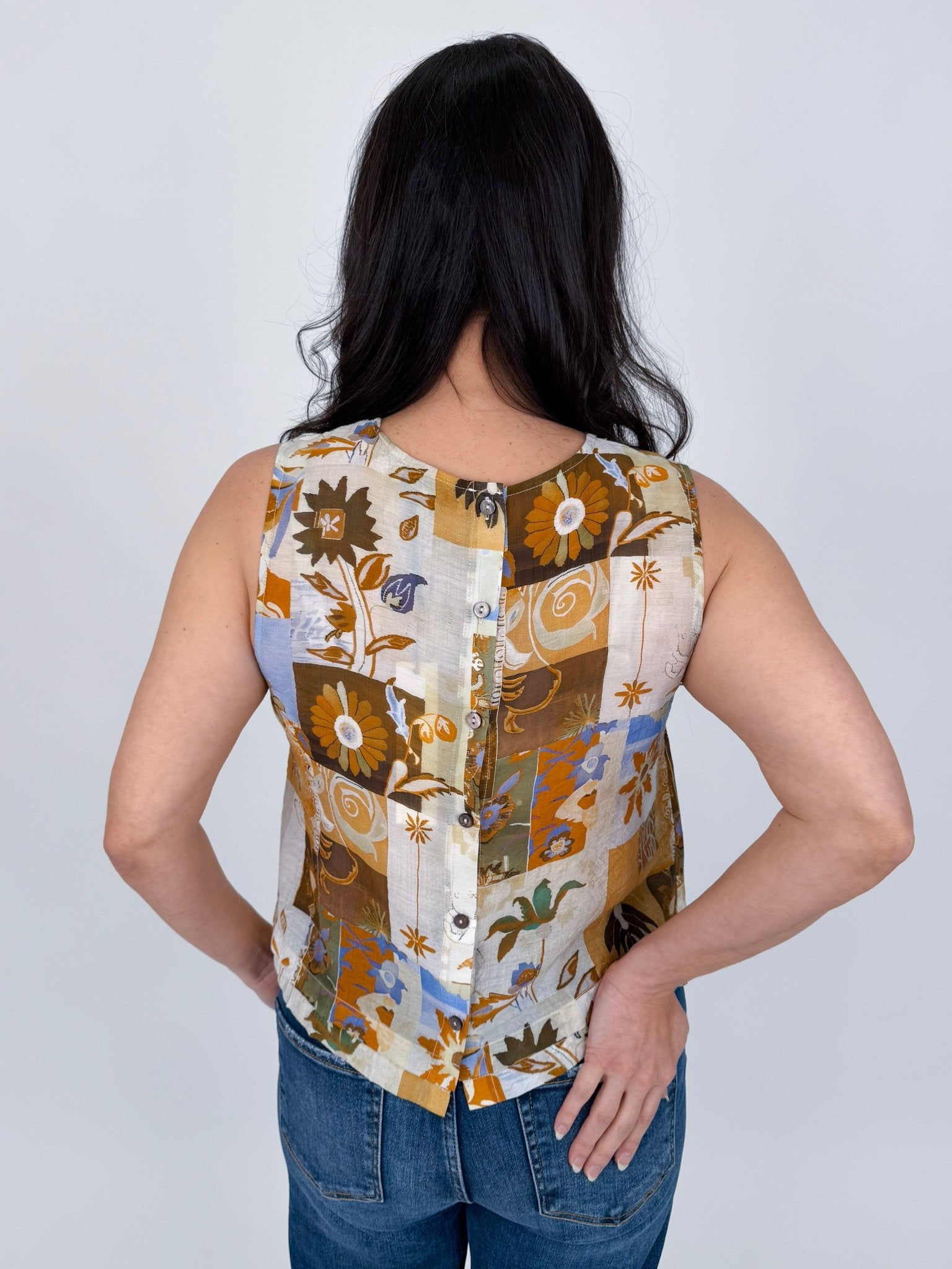 Jenny Lee Mixed Print Blouse in golden amber patchwork floral print with high round neckline and sleeveless silhouette
