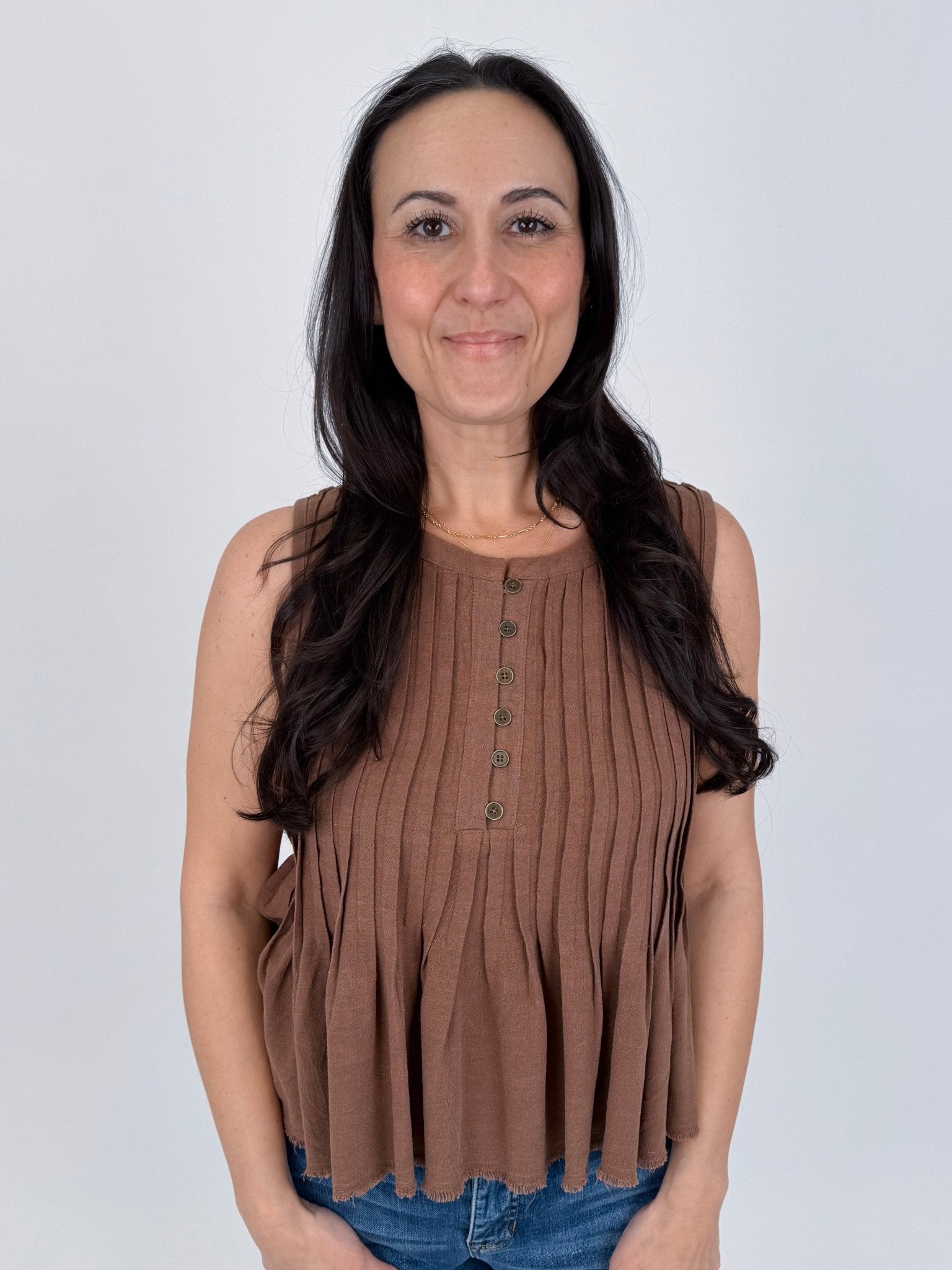 Betsey Pleated Blouse in mocha and off white with vertical pleated front, antique button detail, and raw frayed hem