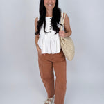 Betsey Pleated Blouse in mocha and off white with vertical pleated front, antique button detail, and raw frayed hem