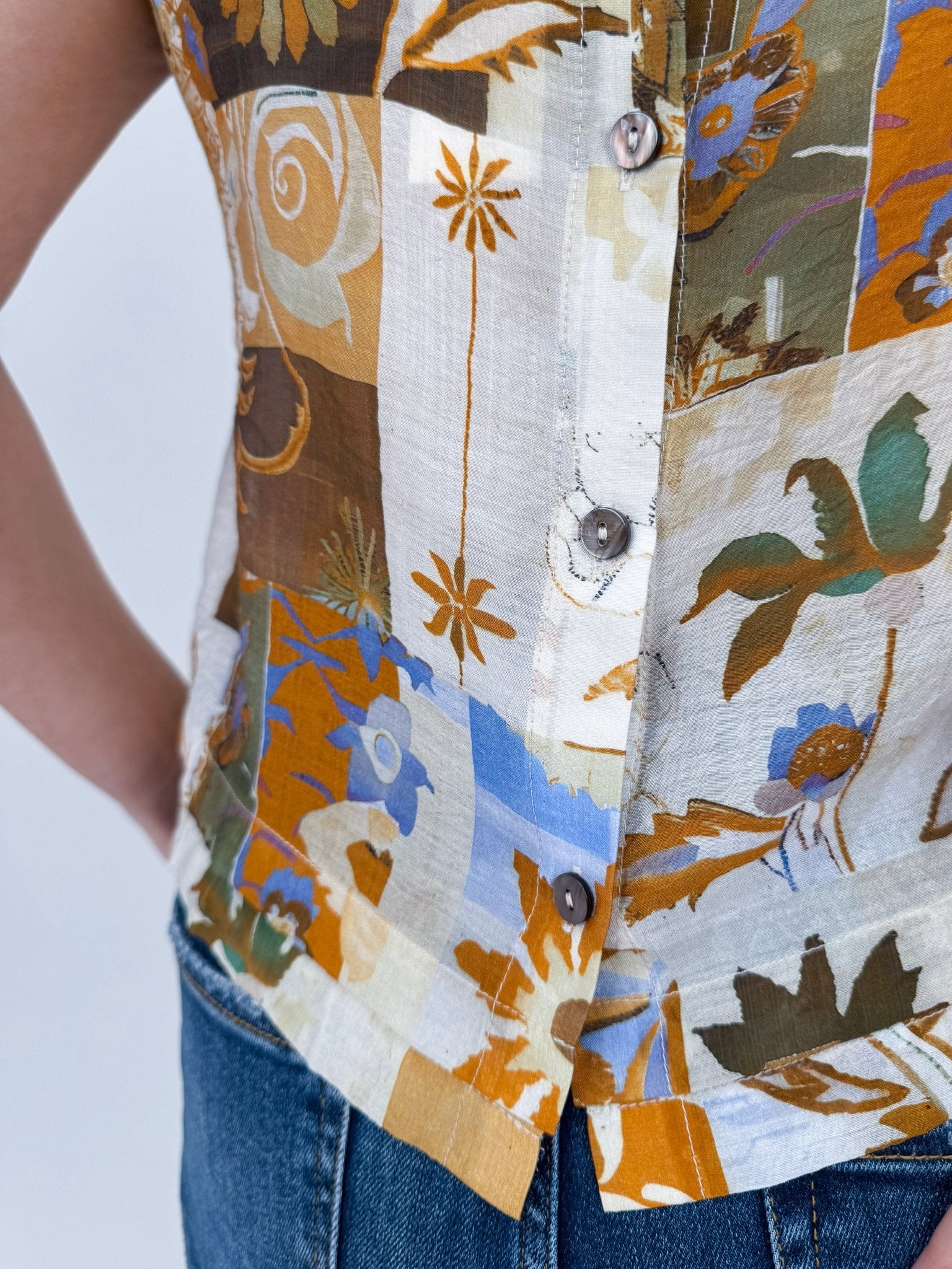 Jenny Lee Mixed Print Blouse in golden amber patchwork floral print with high round neckline and sleeveless silhouette